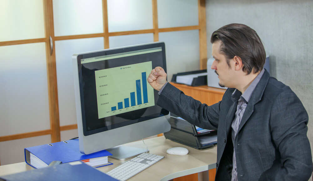 Young businessman working from his office - the concept of success